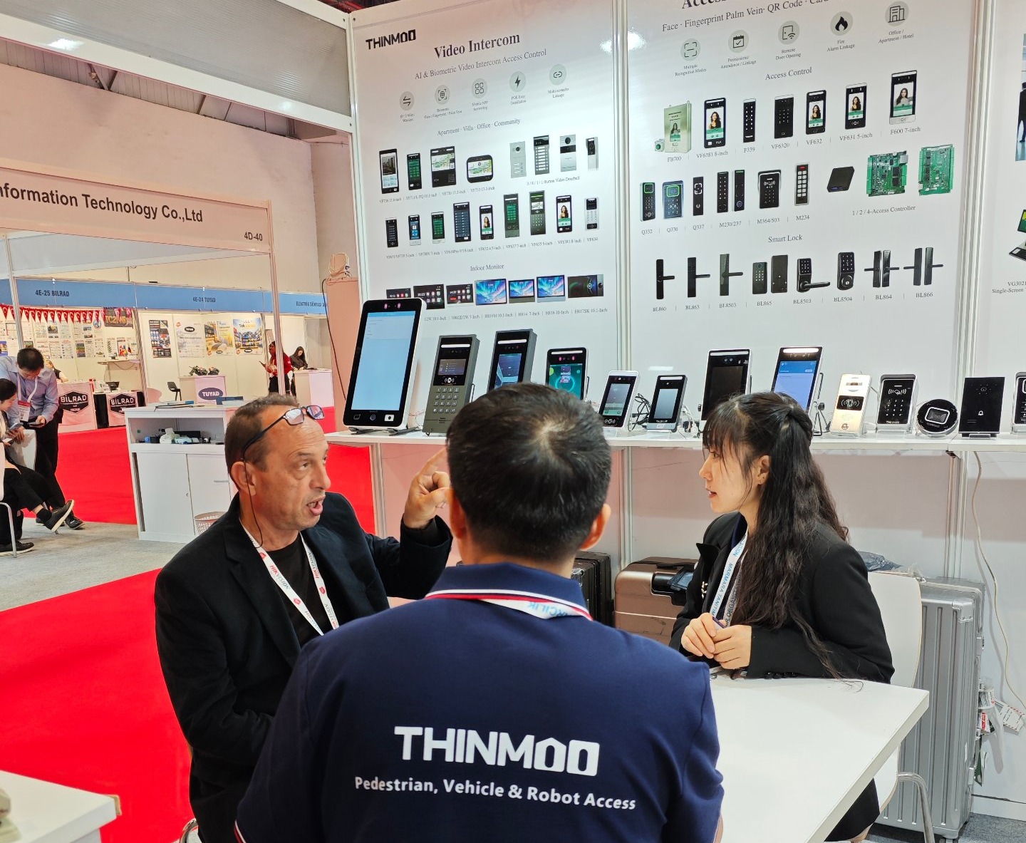 Visitors in conversation at the booth counter